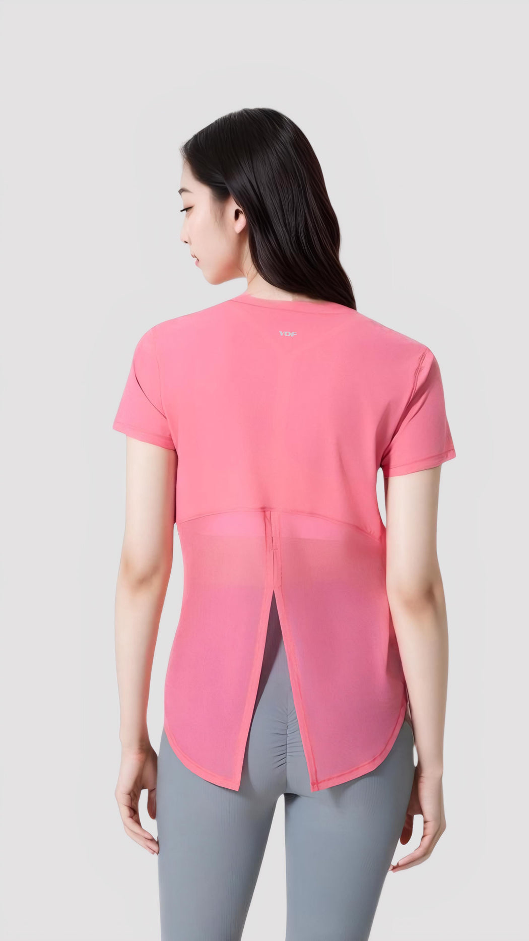 Woman wearing a pink Aero Flow Active Tee showing back slit design and breathable lightweight fabric.
