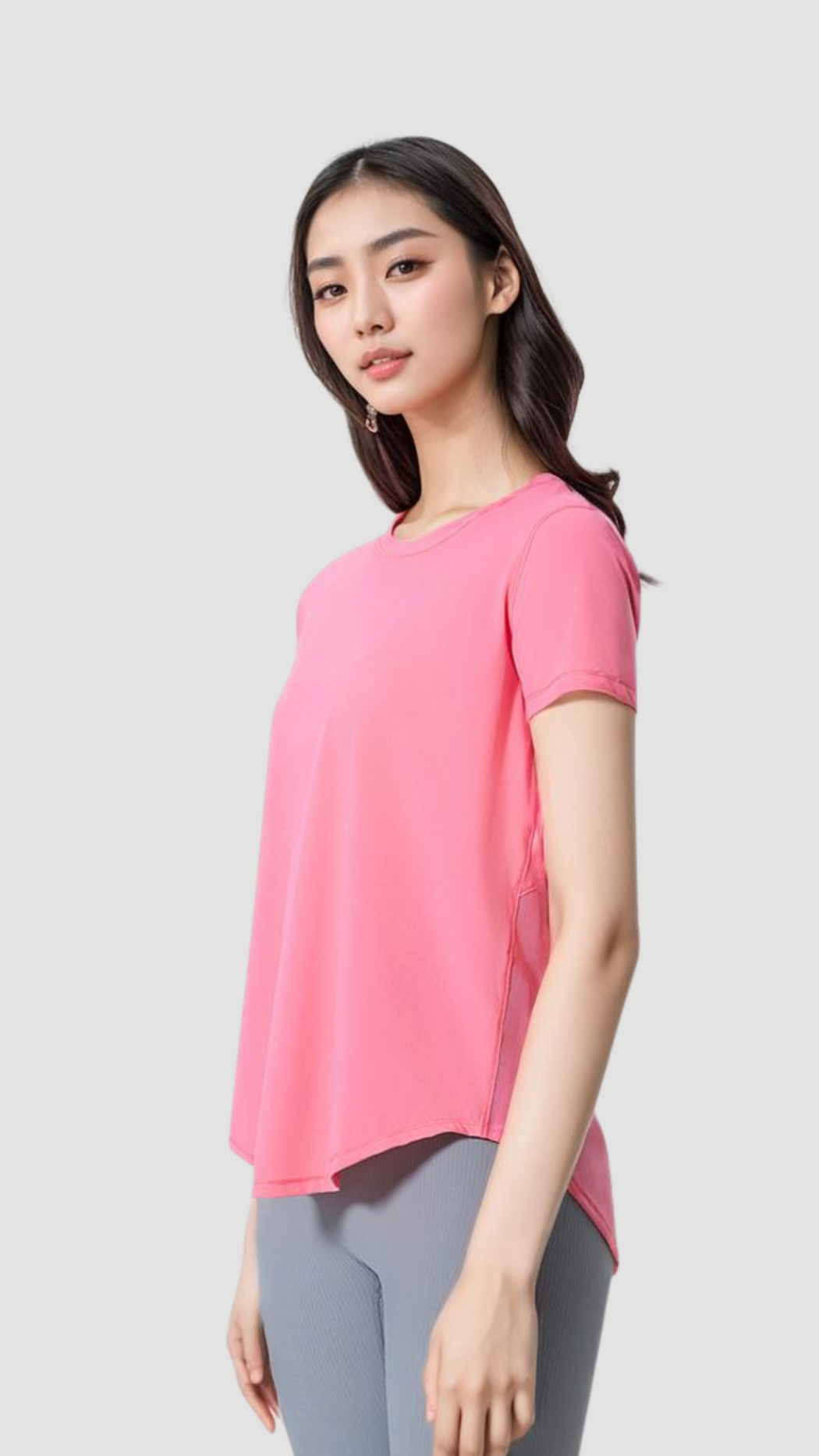 Woman wearing pink Aero Flow Active Tee with round neck, short sleeves, and back slit detail for breathability.