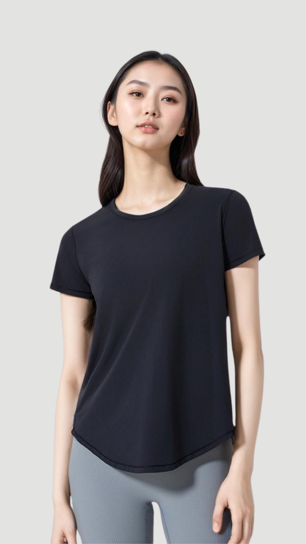 Woman wearing a black Aero Flow Active Tee with a round neck and lightweight breathable fabric.